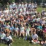 Campers sit on hillside for group picture at Nike Softball Camp Amherst College