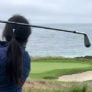Camper hits iron tee shot with ocean view Nike Junior Golf Camps