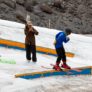 Windells Ski Camp camper learns to ride flat bar with coaches help jpg