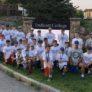 Baseball camp group photo in front of Endicott College sign