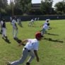 Athletes running in the outfield during baseball camp