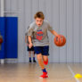 Boys Running With Ball at the youth basketball camp