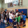 Brown Middle School youth basketball camp team huddle