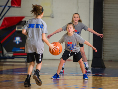 Deceptive players tip on basketball court at youth summer camp