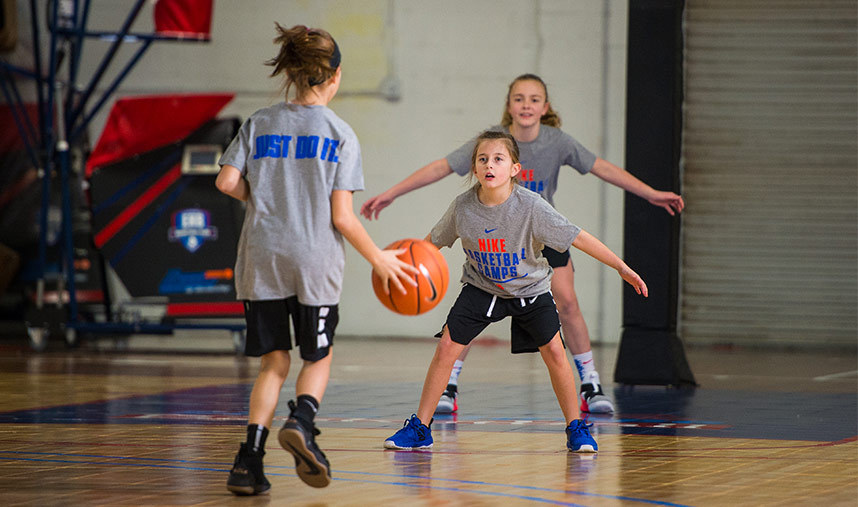 Deceptive players tip on basketball court at youth summer camp