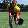 Softball camper dives to catch a ball in the outfield