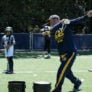 Cal Softball Coach Demonstrating Swing to onlooking campers
