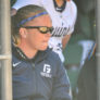 George Fox Softball Head Coach Jessica Hollen in dugout Camp