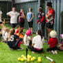 Athletes watch as coach gives instruction at indoor facility