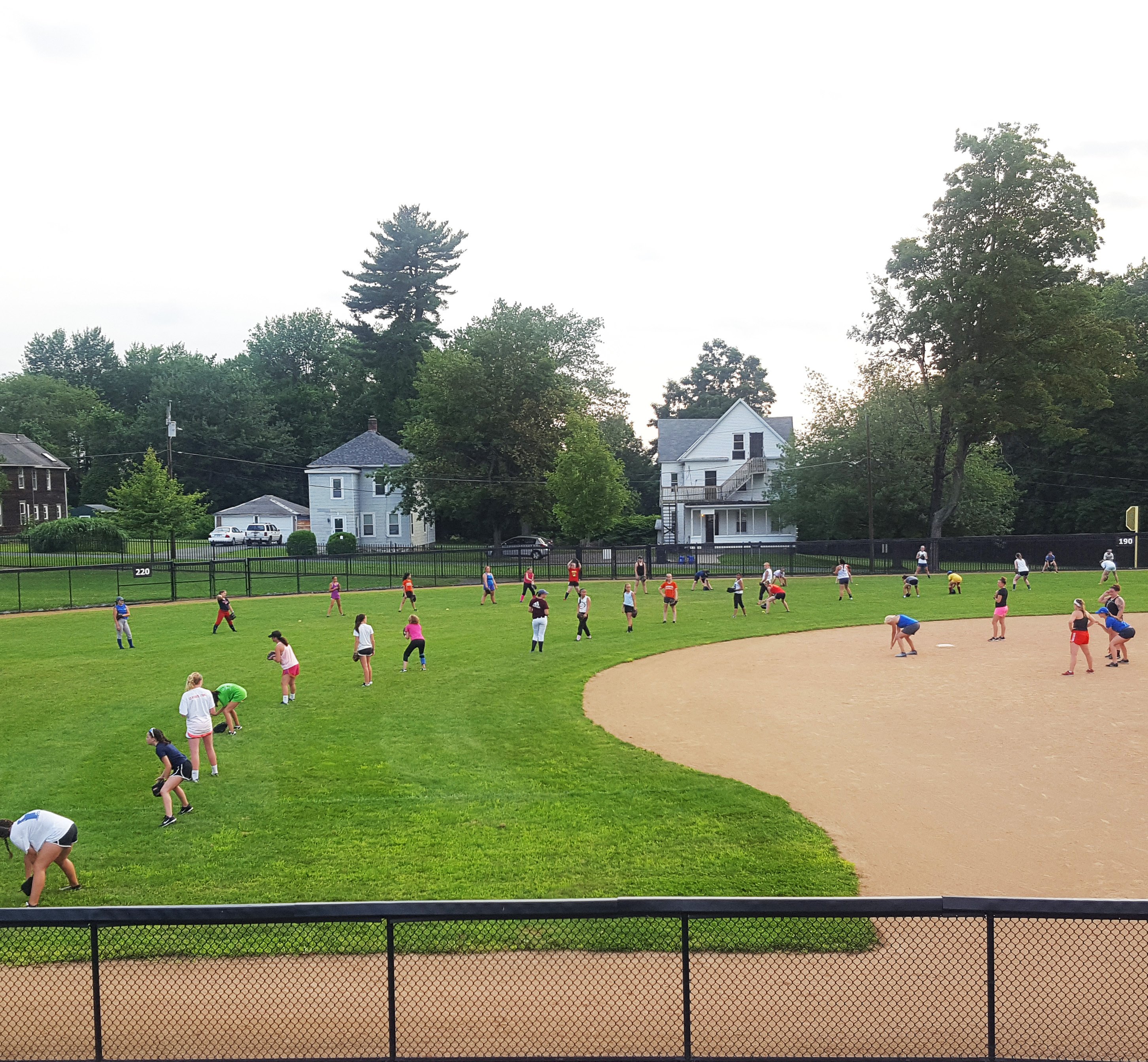 Softball campers lined up in the outfield for drill