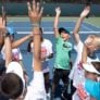 Tennis kids hands in the air